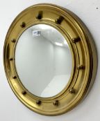Small circular brass finished frame convex wall mirror