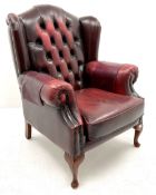 Georgian style wing back armchair upholstered in studded deep buttoned oxblood leather