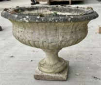 Low composite stone urn on square base