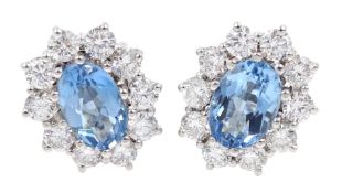 Pair of 18ct white gold oval aquamarine and diamond cluster stud earrings