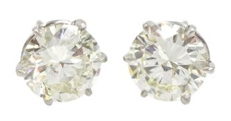 Pair of platinum round brilliant cut diamond stud earrings