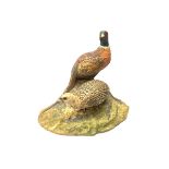 A North Light figure modelled as a cock and hen pheasant upon rocky ground