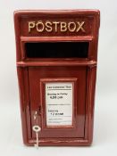 A reproduction red painted postbox