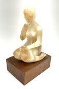 Ann Baxter (British b. 1969): Alabaster figure of a seated lady on rectangular wooden plinth