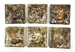 A set of six late 19th/early 20th century mottles green and brown glazed tiles