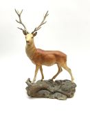 A Beswick Connoisseur matt model of a Stag upon a rocky modelled base