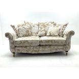 Two seat sofa upholstered in a pale gold ground fabric with floral pattern
