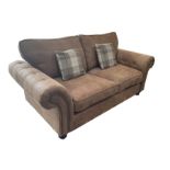 Two seat sofa upholstered in studded and buttoned suede fabric