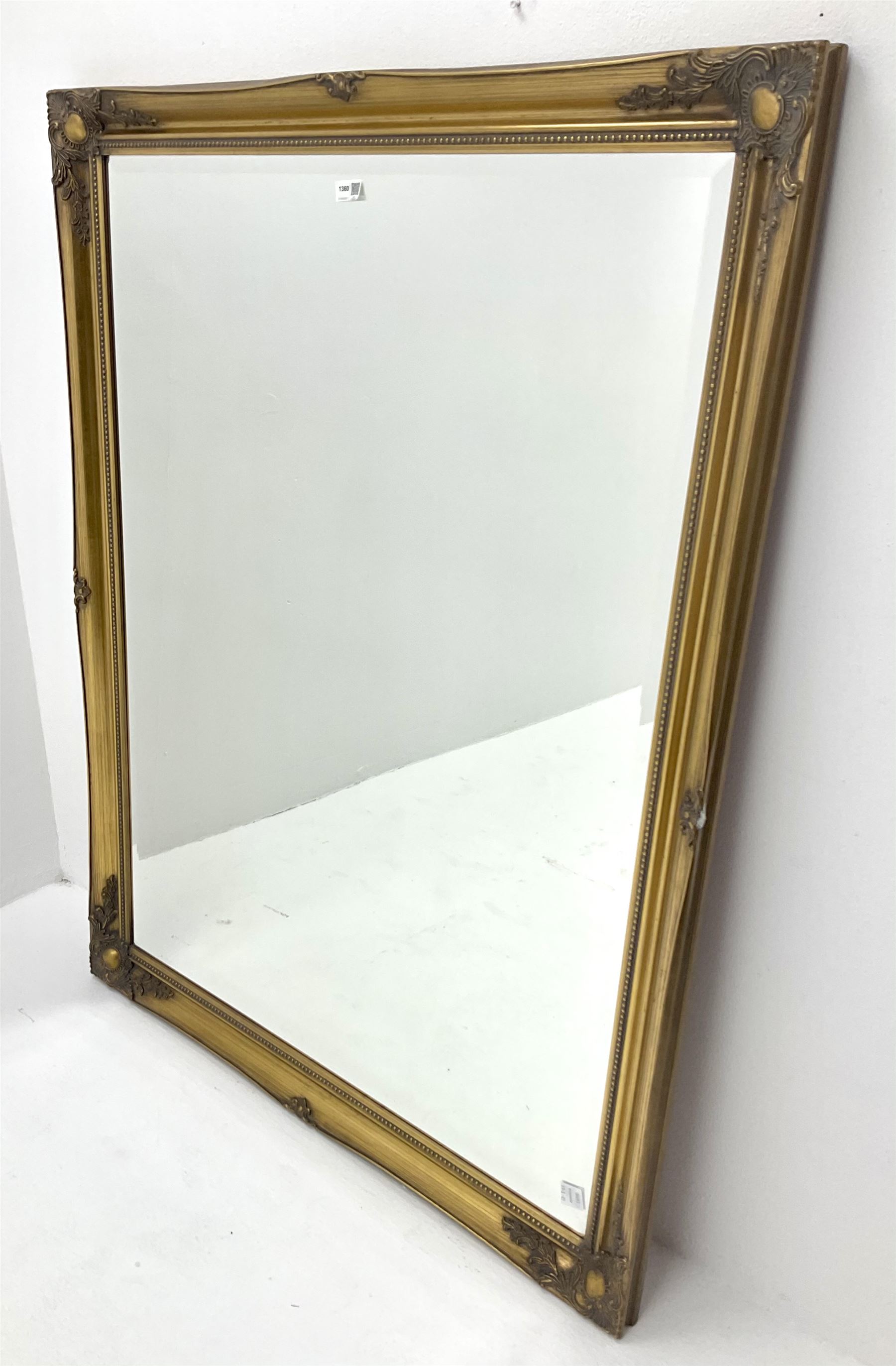 Large bevel edge wall mirror in traditional gilt frame