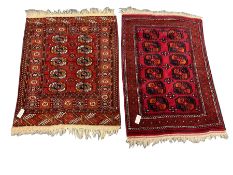 Two small Persian red ground rugs (122cm x 80cm and 111cm x 86cm)