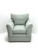 Traditional shaped armchair upholstered in duck egg blue fabric