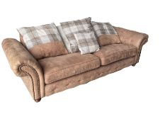 Four seat sofa upholstered in studded and buttoned suede fabric