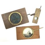 Two wood framed hand cranked rack and pinion chromatrope glass magic lantern slides