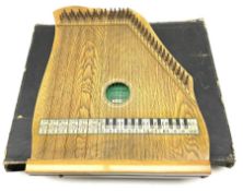 Supertone Stringed Accordian by Abbley & Son London with simulated oak finish and transferred keyboa