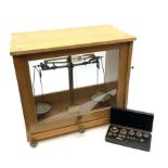 Set of Baird & Tatlock laboratory scales in oak case with rise-and-fall glazed front W39cm H36cm; wi