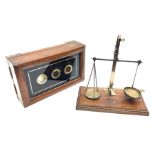 Set of brass and steel balance scales with rise-and-fall action on mahogany oblong base with moulded