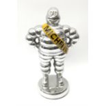 A polished aluminium Michelin man figure