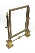 A brass table top swing mirror