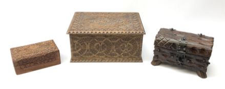 An oak box with carved geometric decoration to the sides and cover