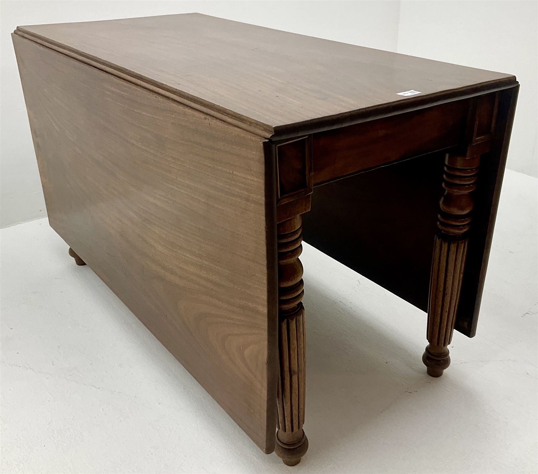 Early 19th century mahogany drop leaf dining table