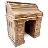 Early 20th century oak twin pedestal shaped tambour roll top desk enclosing fitted interior