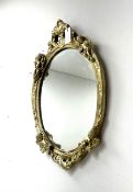 Ornate gilt framed oval mirror