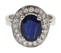 White gold oval sapphire and diamond cluster ring