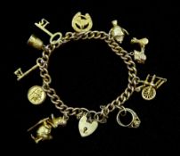 9ct gold curb chain bracelet with heart locket and ten 9ct gold charms including Donald Duck