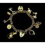 9ct gold curb chain bracelet with heart locket and ten 9ct gold charms including Donald Duck