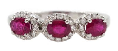 White gold three stone oval ruby and round brilliant cut diamond cluster ring