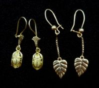Pair of leaf design gold earrings and pair of gold beetle pendant earrings