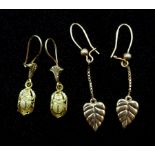 Pair of leaf design gold earrings and pair of gold beetle pendant earrings