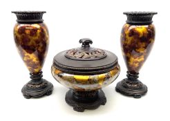 A three piece bronzed composite garniture