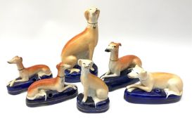 A group of Victorian Staffordshire and later figures modelled as greyhounds