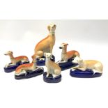 A group of Victorian Staffordshire and later figures modelled as greyhounds