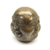 A bronzed four faced buddha head
