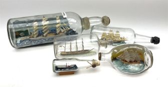 A group of five various sized 'Ship-in-a-bottle' ornaments