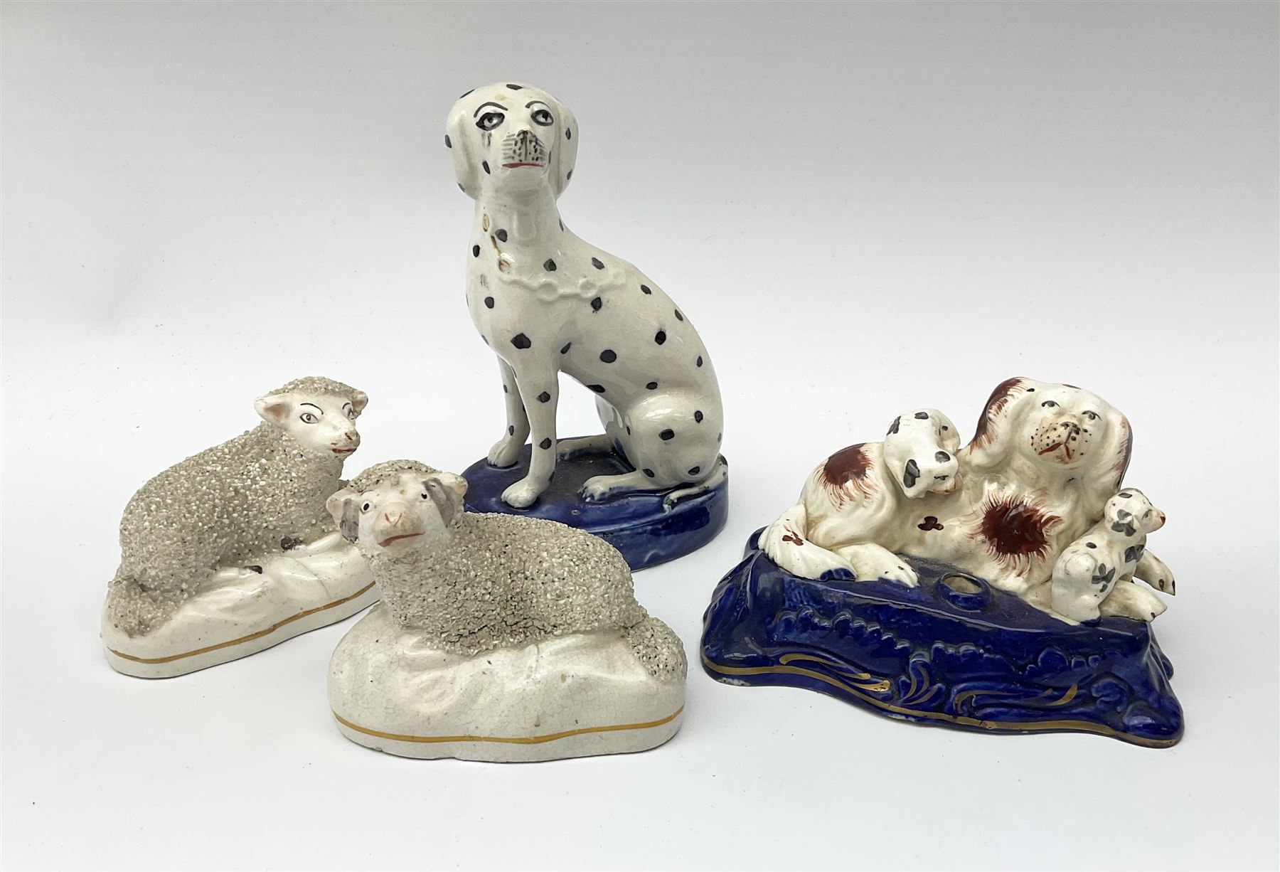 A Victorian Staffordshire figure group pen holder modelled as a Spaniel and puppies