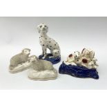 A Victorian Staffordshire figure group pen holder modelled as a Spaniel and puppies