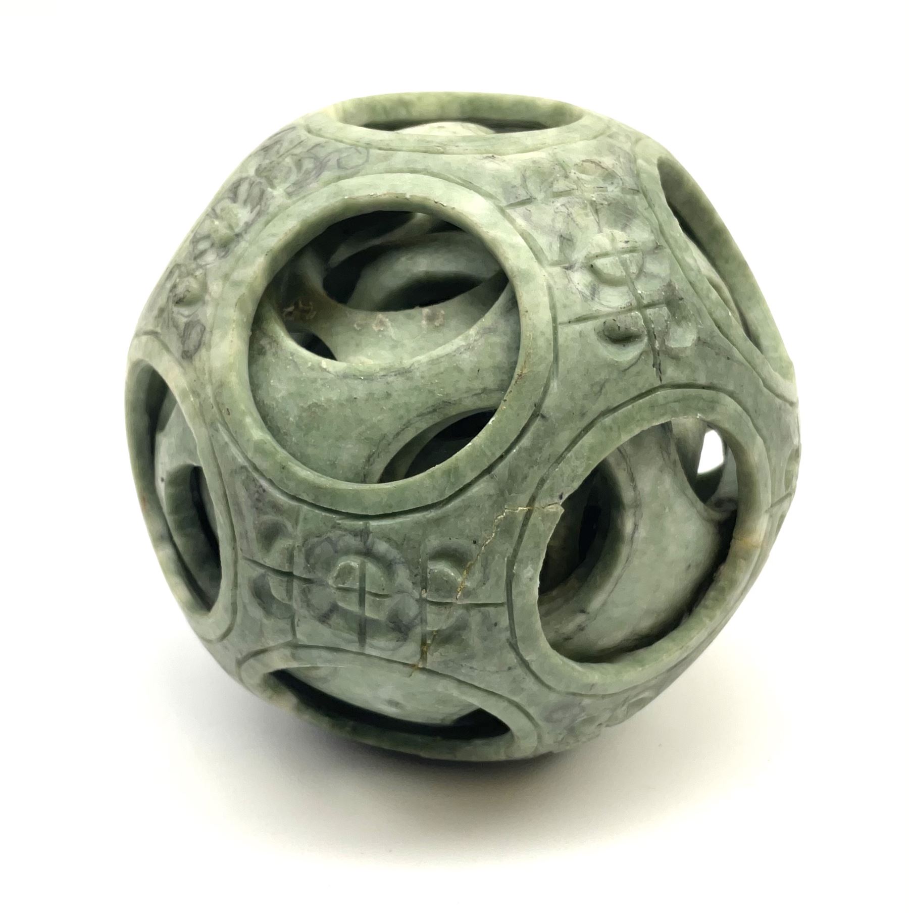 A carved Chinese soap stone puzzle ball with six concentric layers