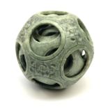 A carved Chinese soap stone puzzle ball with six concentric layers