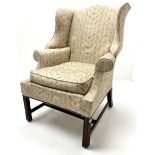 Georgian style mahogany framed wingback armchair upholstered in a beige ground fabric