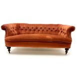 Victorian three seat settee upholstered in deep buttoned terracotta fabric