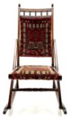 19th/20th century beech framed folding rocking chair with Persian saddle bag covers