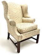 Georgian style mahogany framed wingback armchair upholstered in a beige ground fabric