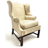 Georgian style mahogany framed wingback armchair upholstered in a beige ground fabric