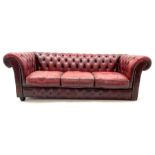 Three seat chesterfield sofa upholstered in deep buttoned ox blood studded leather