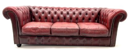 Three seat chesterfield sofa upholstered in deep buttoned ox blood studded leather