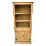Pine open bookcase on cupboards