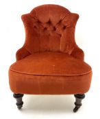 Victorian nursing chair upholstered in a buttoned terracotta fabric